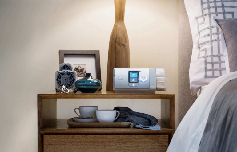 ResMed AirCurve 10 BIPAP sitting on nightstand