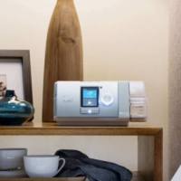 ResMed AirCurve 10 BIPAP sitting on nightstand thumbnail