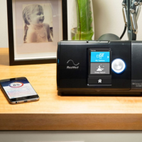 airsense 10 pictured bedside with phone that has sleep tracking app thumbnail